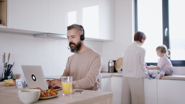 Father working at home and having work meeting. Homeoffice concept.