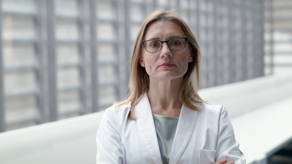 A front view of of woman doctor looking at camera, corona virus concept.