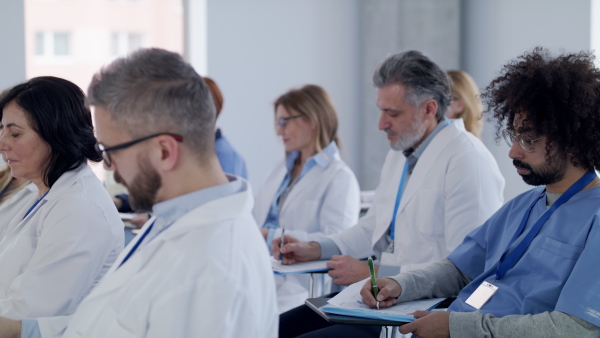 A group of doctors listening to presentation on medical conference.