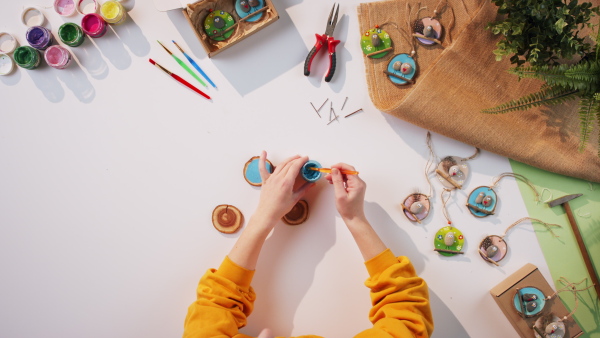 A top view of unrecognizable craftswoman making diy decorations, small business and desktop concept.