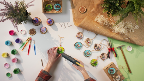 A top view of unrecognizable craftswoman making diy decorations, small business and desktop concept.