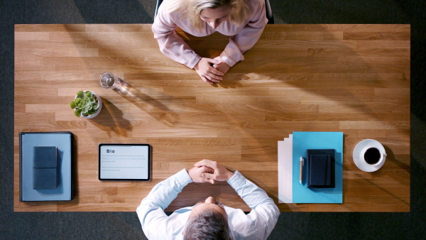 Top view of young woman having a job interview.