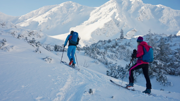 Ski touring couple hiking up a in the mountains.