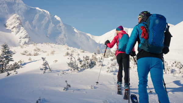 Ski touring couple hiking up a in the mountains.