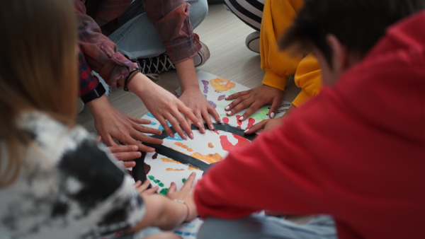 A cut out of students praying for peace in world at school.