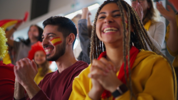 Spanish football fans celebrating their team's victory at a stadium.