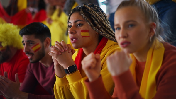 Dissapointed football fans supproting spanish national team in live soccer match at stadium.