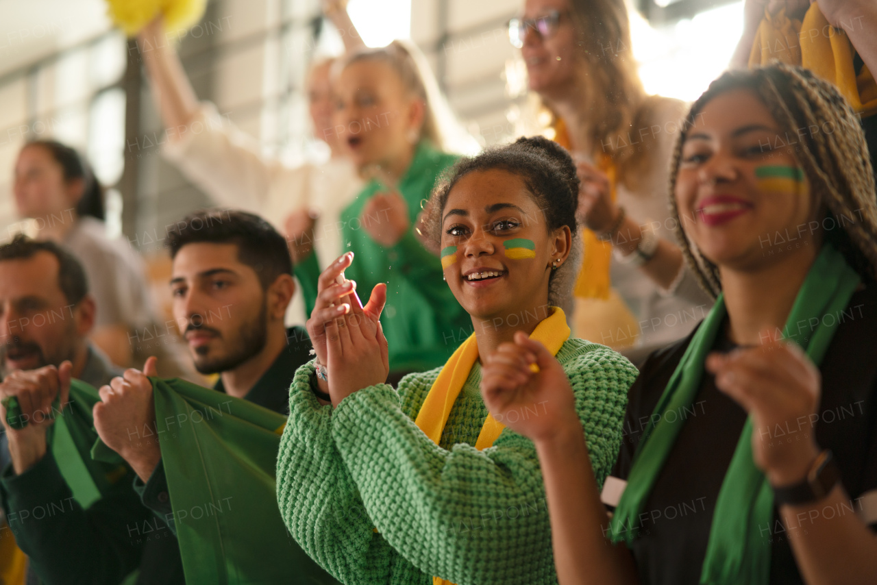 Brazilian young sisters football fans supporting their team at a stadium.