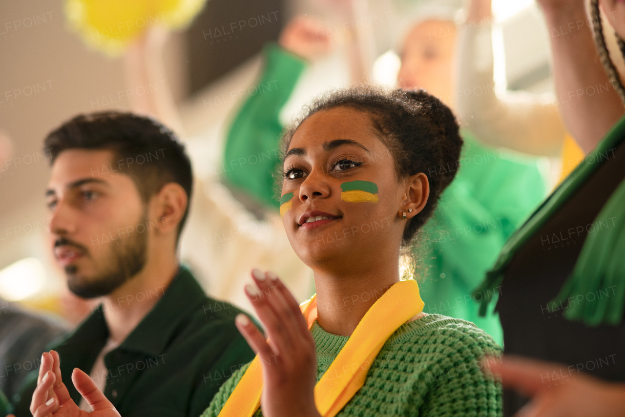 Brazilian young football fans celebrating their team's victory at a stadium.