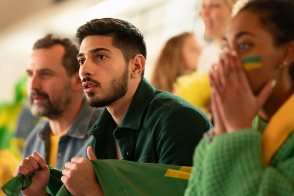 A brazilian football fans supporting their team at a stadium.