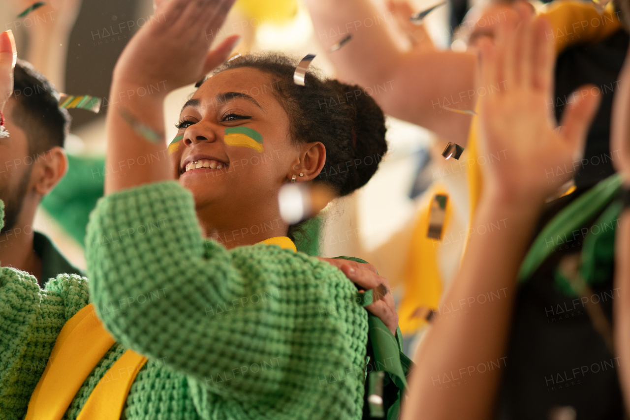 Brazilian young football fans celebrating their team's victory at a stadium.