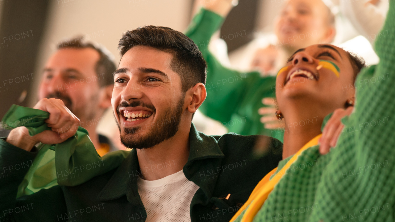 Brazilian young football fans celebrating their team's victory at a stadium.