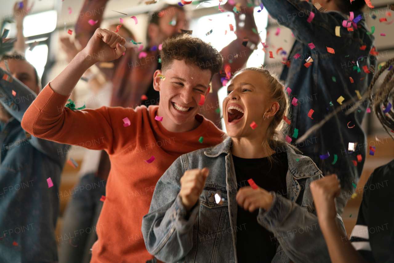 Happy, excited fans celebrating the win in live match at stadium.