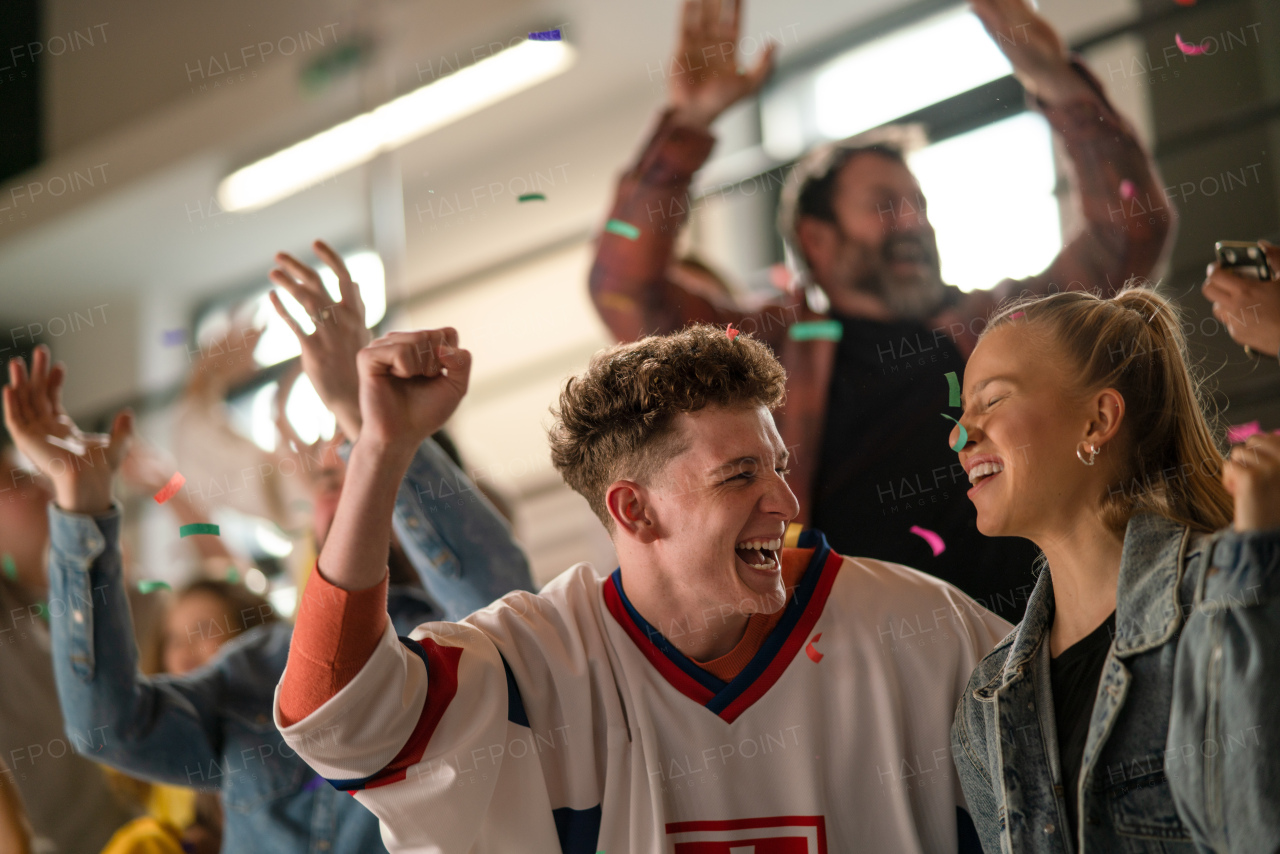 Excited fans supproting Slovak national team in live match at a stadium.