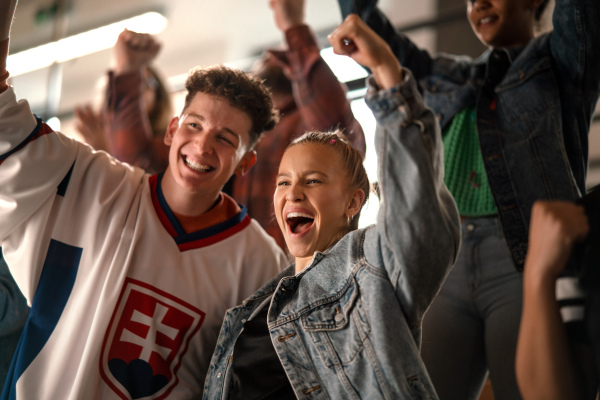 Excited fans supproting Slovak national team in live match at a stadium.