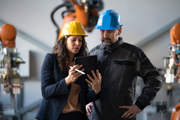 Female engineering manager and mechanic worker inside the factory