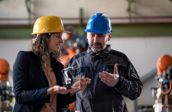 Female engineering manager and mechanic worker inside the factory