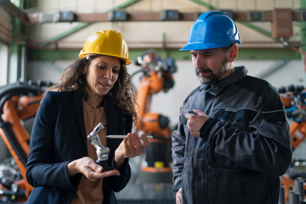 Female engineering manager and mechanic worker inside the factory