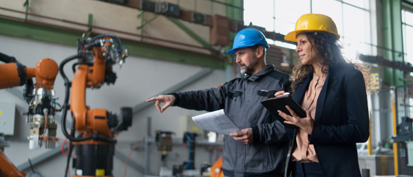 Female engineering manager and mechanic worker inside the factory