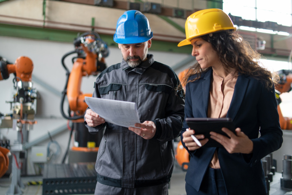 Female engineering manager and mechanic worker inside the factory