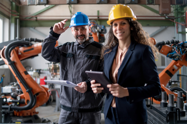 Female engineering manager and mechanic worker inside the factory