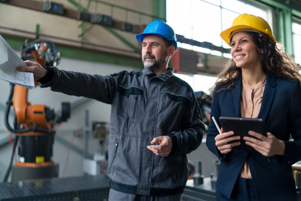 Female engineering manager and mechanic worker inside the factory