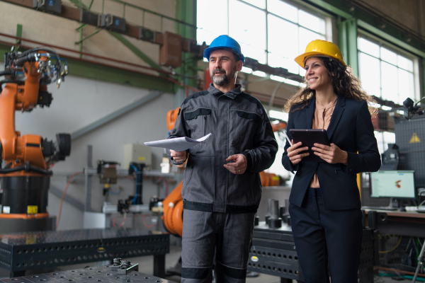 Female engineering manager and mechanic worker inside the factory