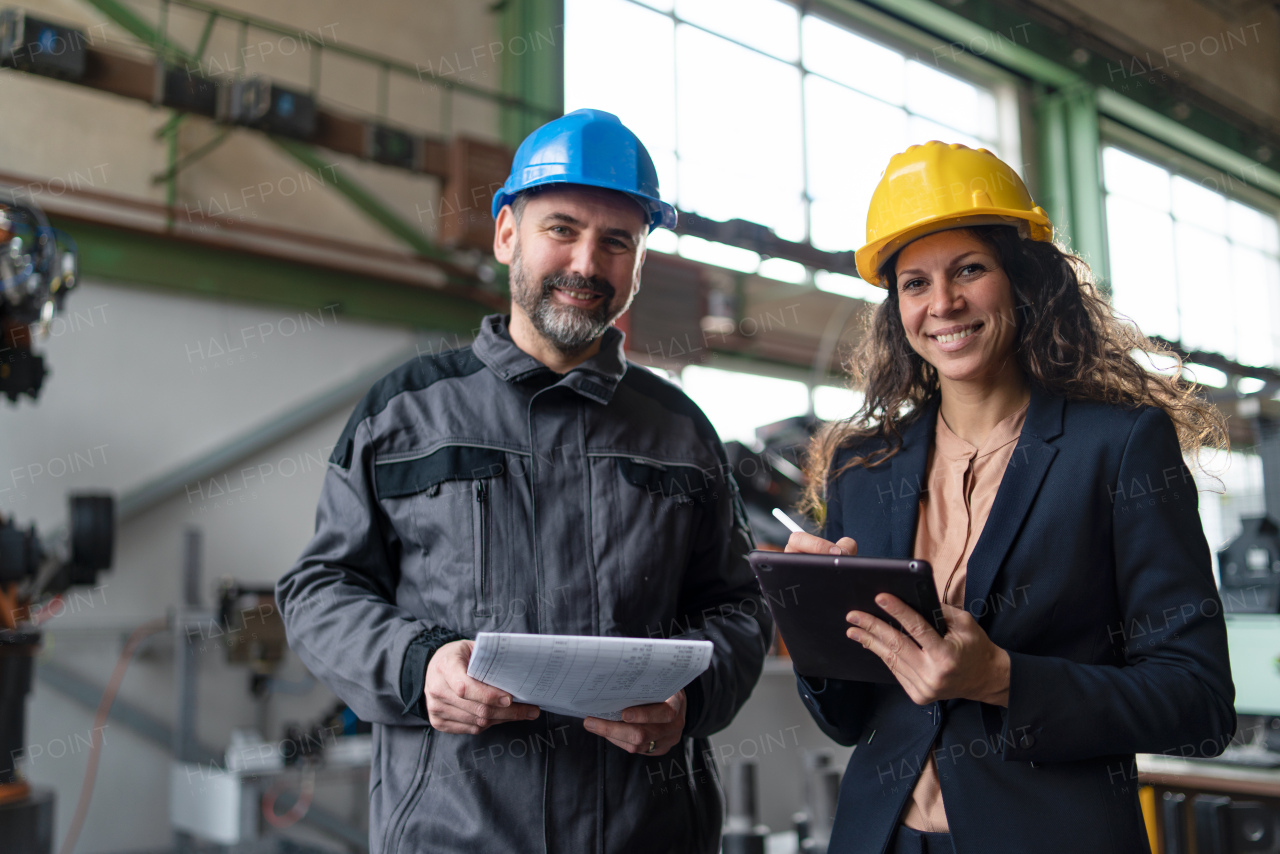 Female engineering manager and mechanic worker inside the factory