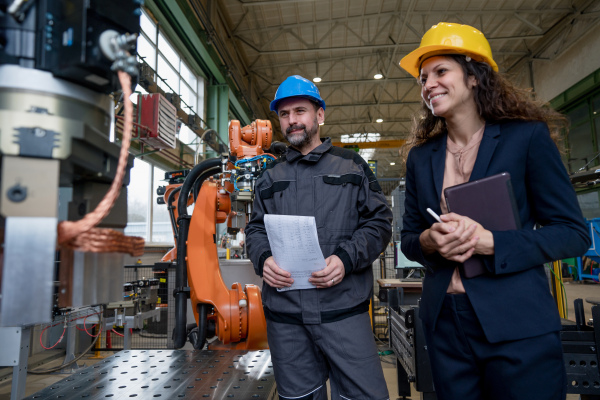 Female engineering manager and mechanic worker inside the factory