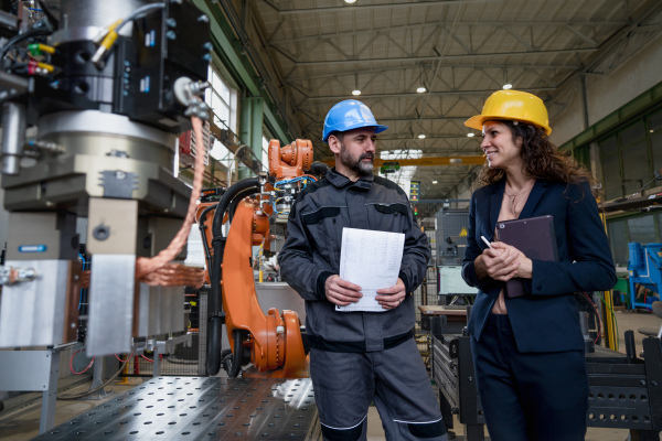 Female engineering manager and mechanic worker inside the factory