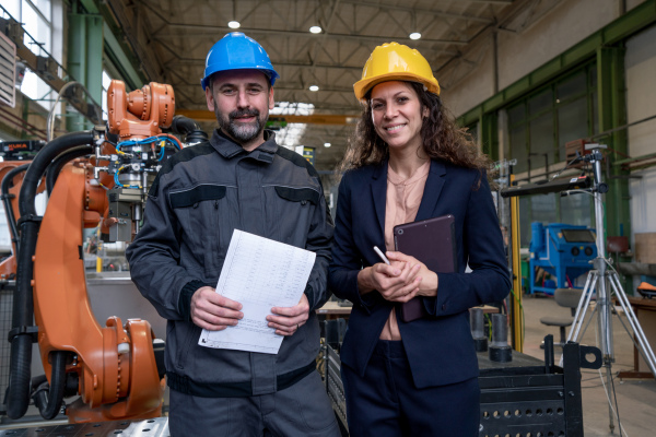 Female engineering manager and mechanic worker inside the factory