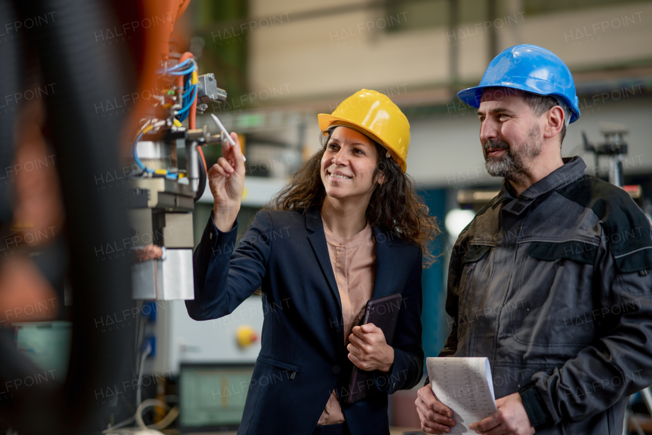 Female engineering manager and mechanic worker inside the factory