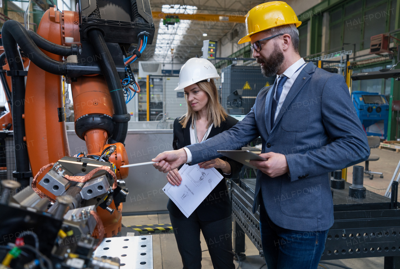 Female engineering manager and mechanic worker inside the factory