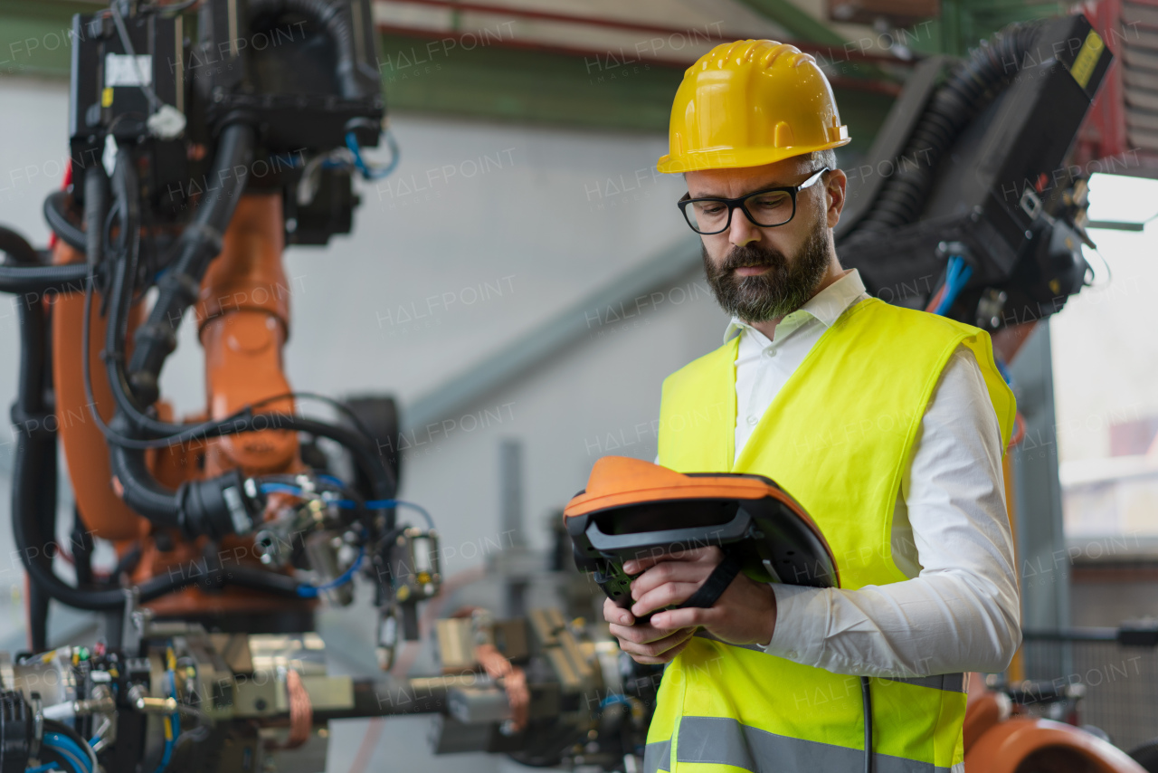 An automation engineer holding scanner in industrial in factory.