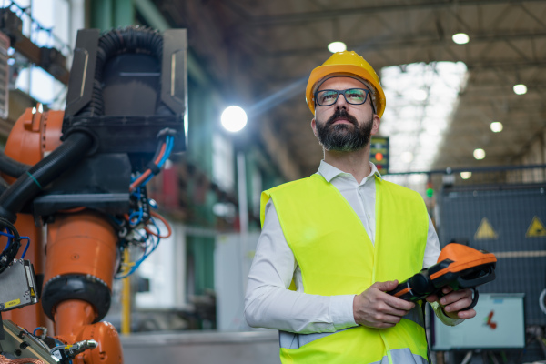 An automation engineer holding scanner in industrial in factory.