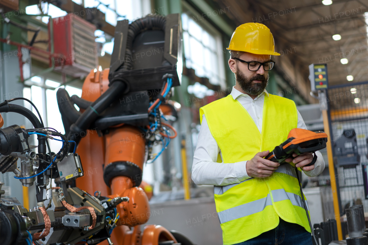 An automation engineer holding scanner in industrial in factory.