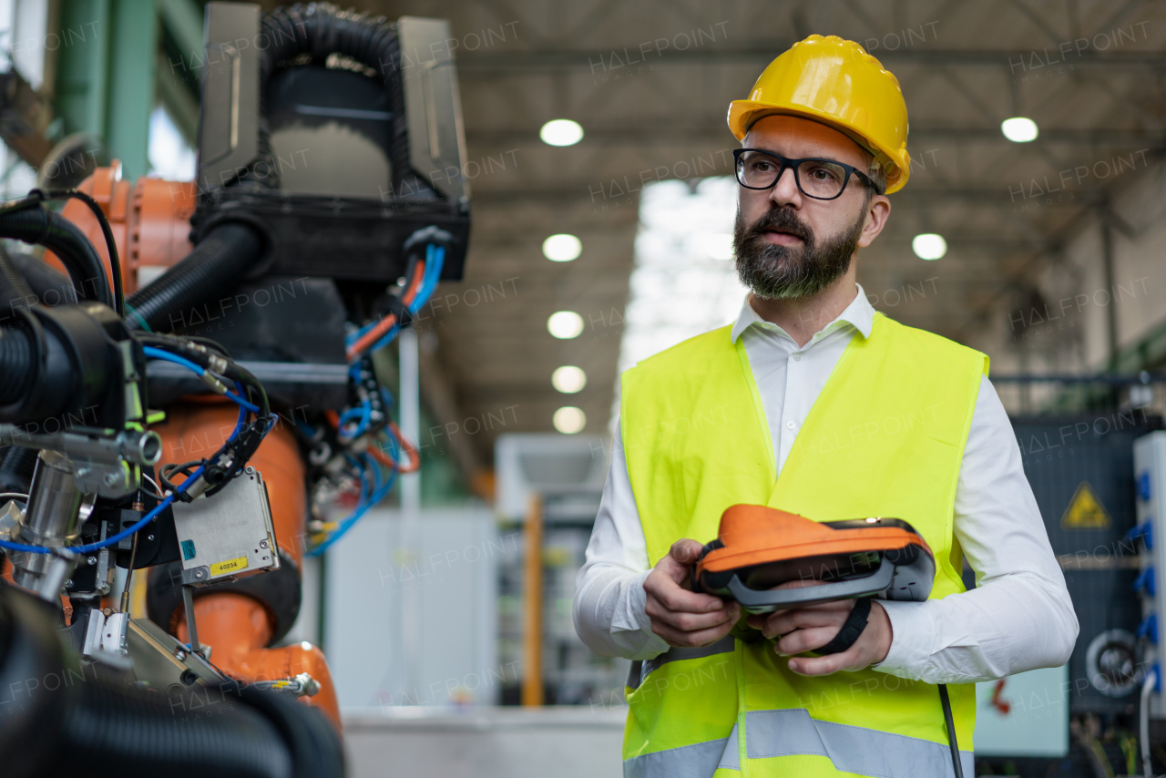 An automation engineer holding scanner in industrial in factory.