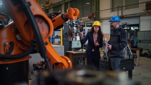 Female engineering manager and mechanic worker inside the factory