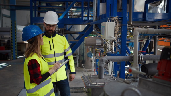 Female engineering manager and mechanic worker inside the factory