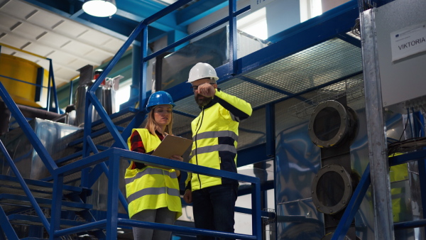 Female engineering manager and mechanic worker inside the factory