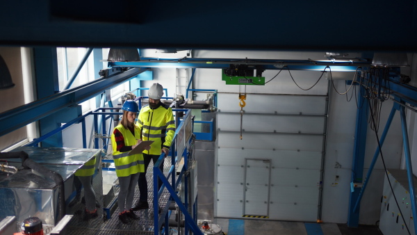 Female engineering manager and mechanic worker inside the factory