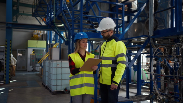 Female engineering manager and mechanic worker inside the factory