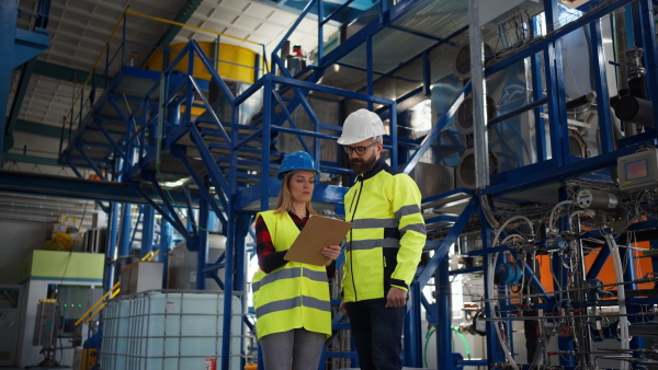 Female engineering manager and mechanic worker inside the factory