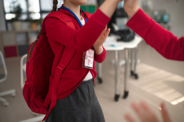 A schoolgirl with blood type sticker at school, Ukrainian war concept.