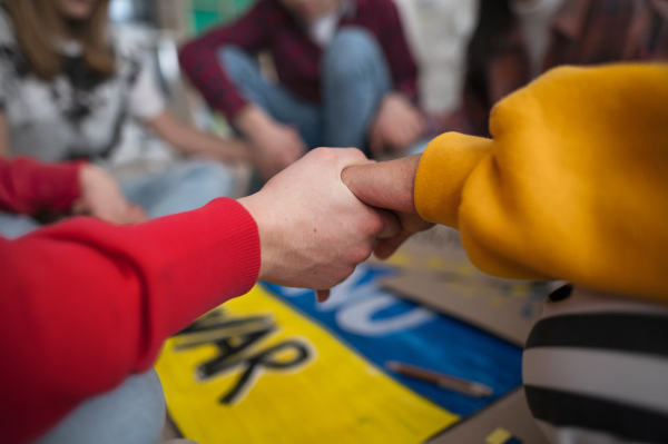 A close-up of students praying for Ukraine at school.