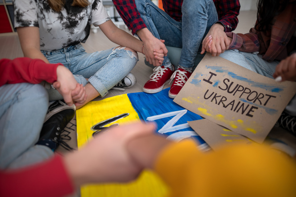 A close-up of students praying for Ukraine at school.