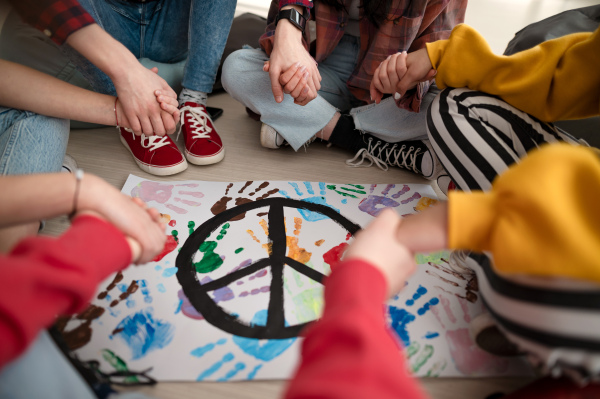 A cut out of students praying for peace in world at school.