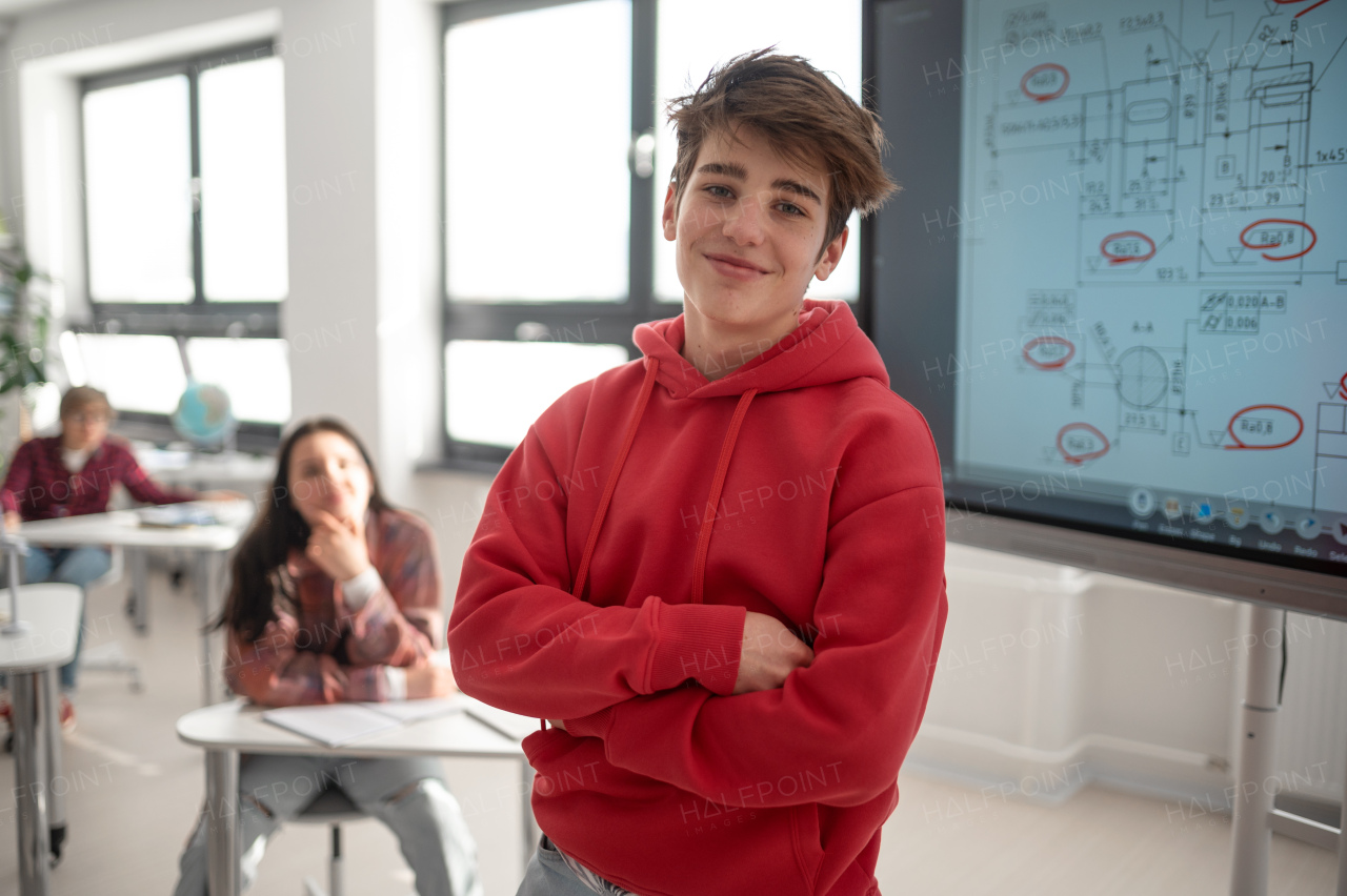 A college student explaining some ideas on a touch TV in classroom.