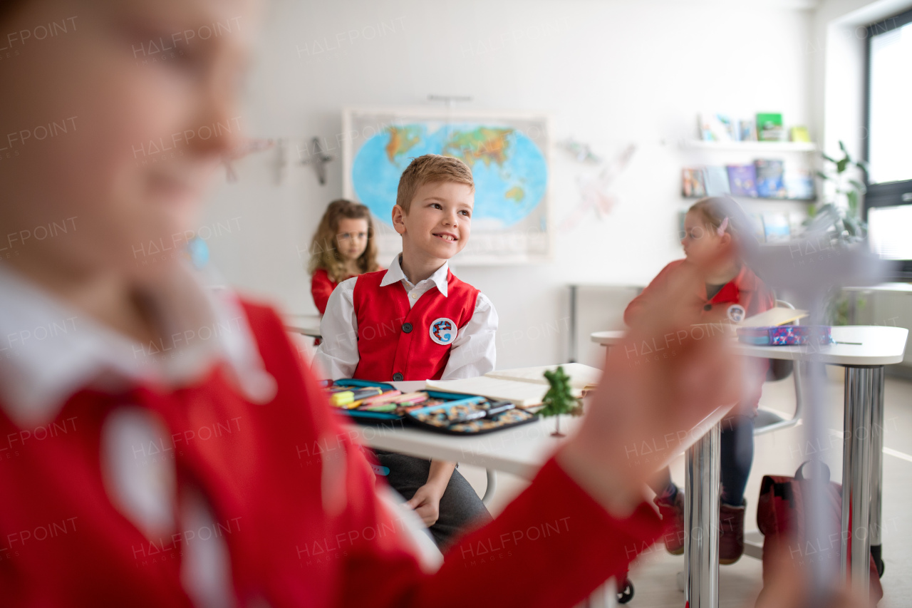 Schoolchildren paying an attention during lesson in classroom at school