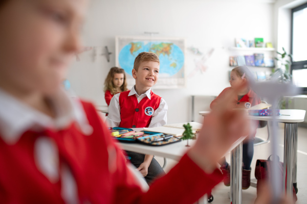 Schoolchildren paying an attention during lesson in classroom at school